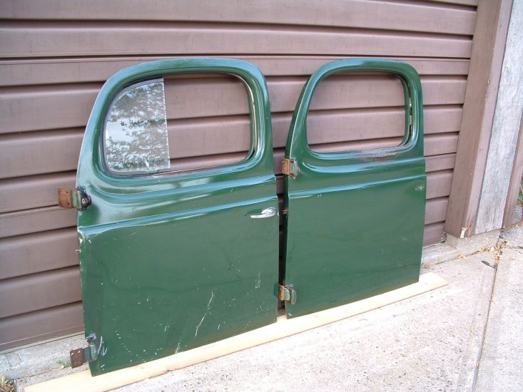 "Dodge Truck Dark Green" Doors
Pair of doors still in original paint. Paint shade is Dodge Truck Dark Green and was used on Dodge Power-Wagons as well as conventional two wheel drive Dodge trucks from 1940 through 1953. Left door is from a WDX model Power-Wagon. Right door is from a conventional two wheel drive truck from 1947 or older.
