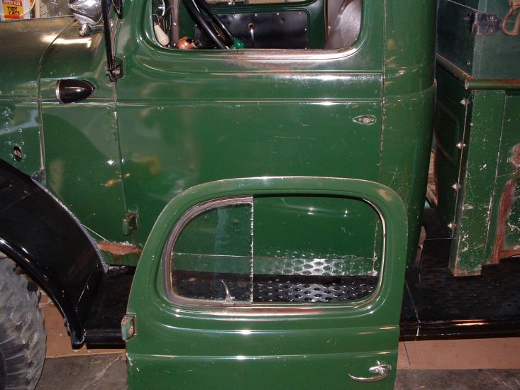 "Dodge Truck Dark Green" Doors
Image showing original driver's door removed from WDX Power-Wagon sitting on floor, and it's replacement mounted to the cab. Replacement door came from a conventional two wheel drive Dodge truck. Both door still wear original Dodge Truck Dark Green paint.
