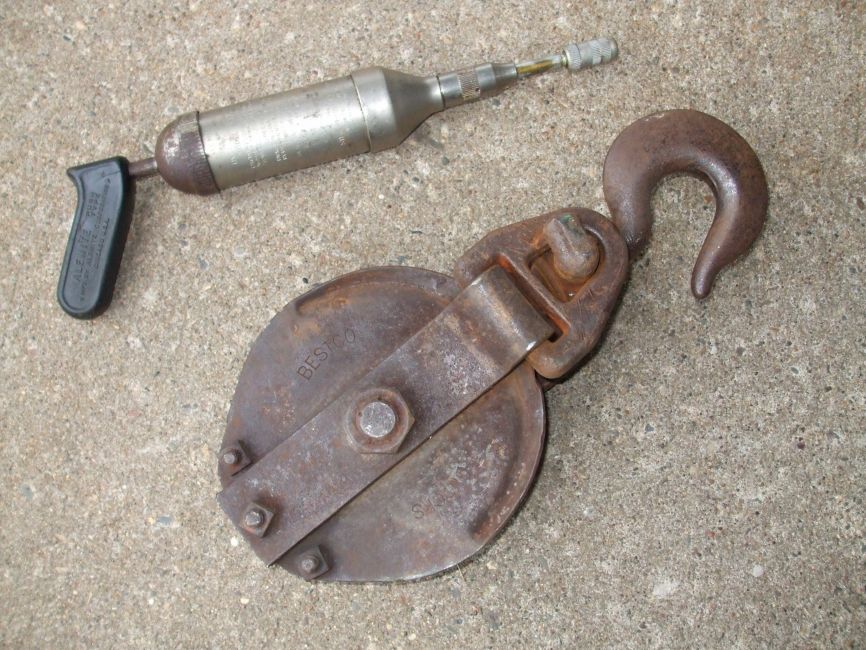 Snatch Block and Grease Gun
Two items delivered with Power-Wagons new from the factory. These may be considered tools, but they were not listed along with the tool kit in the "Group 20 Tools" section of the parts manuals.

The snatch block is listed in the section titled "Group 21 Transmission" as: Part Type Code - 21-97-18; BLOCK, Winch Cable Snatch; Part No. - 915 815.

The grease gun is listed in the "Standard Parts List" that covered Group 18 standard hardware, fittings, clips, etc. for all Chrysler vehicles as: Part Type Code - 18-97-2; GUN - Lubricating, Type C; Part No. 144 498.
