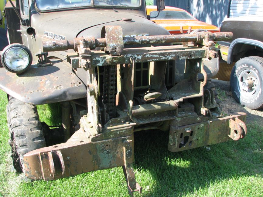 brackets for A frame, bar on top is for a capstan winch sheave to install on either side and chain driven from winch shaft. Hole in bumper looks like a shaft may have been mounted there.
